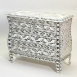An Indian bone inlaid bombe chest, with ornate floral and foliate penwork decoration,