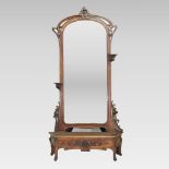 An early 20th century continental carved walnut mirror,