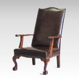 A brown upholstered wing armchair,