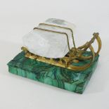 A Russian malachite, gilt bronze and rock crystal mounted desk stand, in the form of a sleigh,