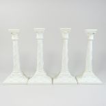 A set of four mid 20th century Royal Worcester white glazed porcelain candlesticks,