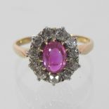 An 18 carat gold and ruby and diamond cluster ring