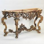 An ornate 18th century carved pine and gilt gesso console table base, of serpentine shape,