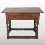 An 18th century oak side table, containing a single drawer, on turned legs,