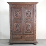 A 19th century North Italian carved oak armoire, with a moulded cornice,