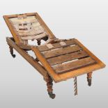 A Victorian teak folding campaign daybed, with a ratcheted back and seat, on removable turned legs,