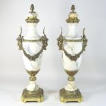 A pair of Classical style bronze mounted marble urns, each of slender urn shape,