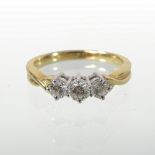 An 18 carat gold and diamond set three stone ring, stamped 760,