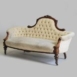 A Victorian carved walnut show frame double ended couch, upholstered in yellow, on turned legs,