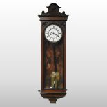 An early 20th century walnut cased vienna style wall clock,