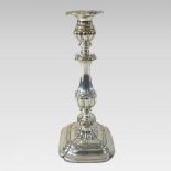 A large silver plated table candlestick, with scrolled decoration,