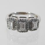 An 18 carat white gold triple cluster diamond ring, set with three princess cut stones,