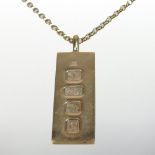 A modern 9 carat gold ingot pendant, mounted on a fine 9 carat gold box link chain,