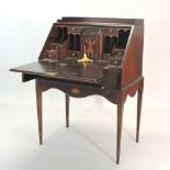 A late 19th century mahogany and inlaid bureau, the fitted stepped interior,