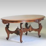 An early 20th century Italian walnut centre table, with an oval top, on an ornate carved base,