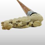 An early 20th century Chinese carved bone handled novelty walking stick, in the form of a figure,