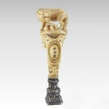 A 19th century continental carved ivory and silver mounted desk seal,
