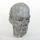 A modern concrete sculpture, life size head of a man,
