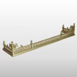 An ornate brass classical revival fender, with rope twist decoration,