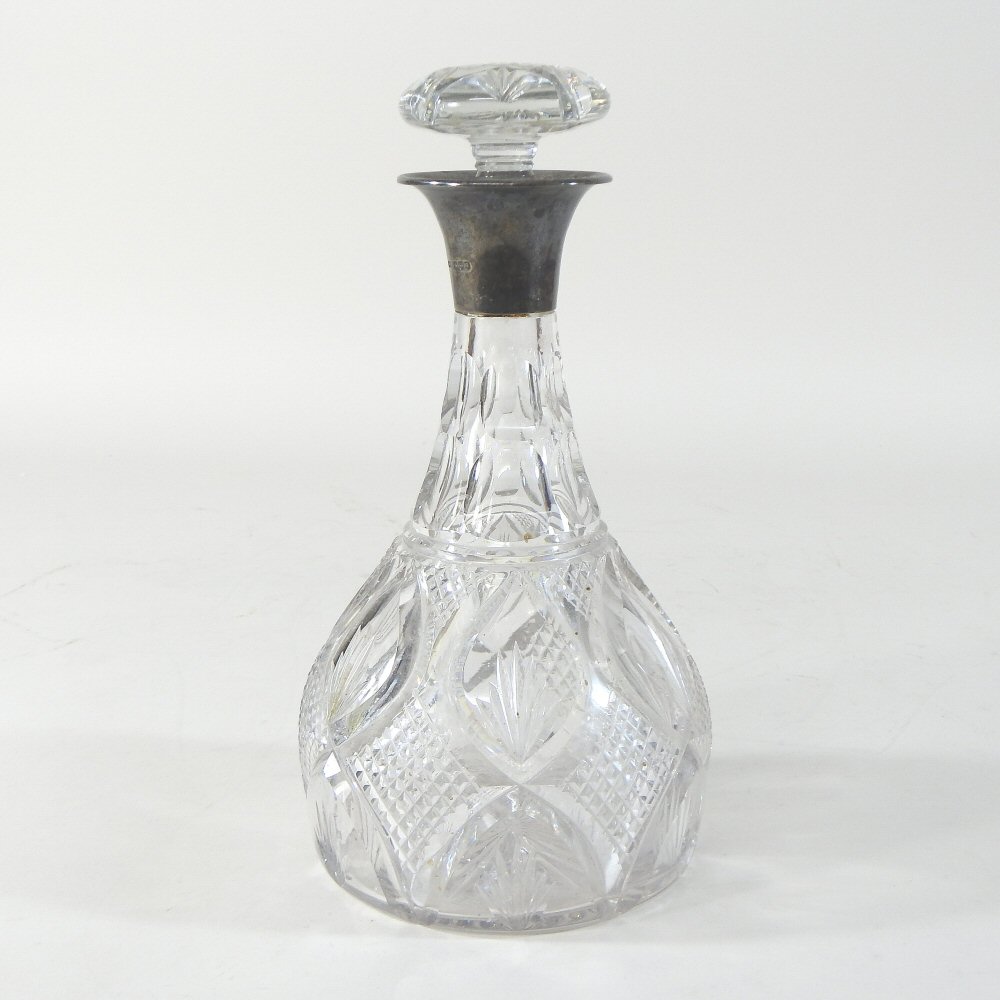 An early 20th century cut glass decanter and stopper, with a silver collar, Sheffield 1918,