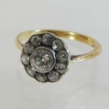 An 18 carat gold and diamond daisy ring,