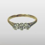 An 18 carat gold platinum set three stone diamond ring,