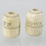 A pair of 19th century turned bone bell pulls, each of bobbin shape, inscribed UP and DOWN,