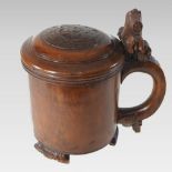 A Norwegian birch ceremonial peg tankard, of turned tapered form, the hinged lid carved with a lion,