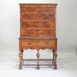 An 18th century and later walnut chest on stand, with satinwood stringing,