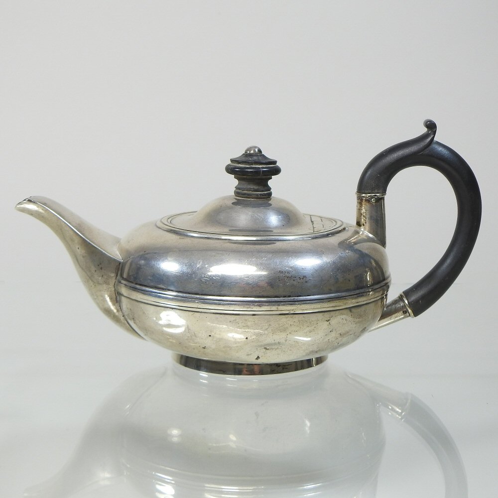 An Edwardian silver teapot, of compressed circular shape, Chester 1904,