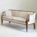 A 19th century carved mahogany sofa, upholstered in cream floral fabric, on turned legs and castors,