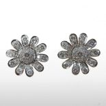 A pair of unusually large 18 carat gold and diamond earrings, of daisy form, each 2.