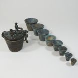 A set of eight 19th century Eastern bronze graduated weights,