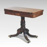 A Regency carved mahogany folding card table, with a hinged rectangular top,