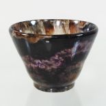 A possibly Blue John stone cup, of plain tapered shape,