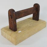 A bootscraper with wooden base,