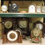 Two shelves of clocks, to include a Georgian style bracket clock and two carriage clocks,