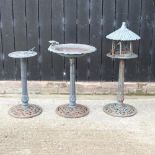 A metal bird bath, together with a feeding table and a sun dial,