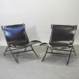 A pair of chrome and brown leather chairs