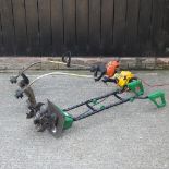 A petrol strimmer, together with another and an electric garden tiller,
