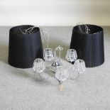 A pair of modern ceiling lights and shades, together with a five branch plated chandelier,