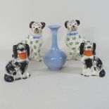 A pair of Staffordshire dogs, 19cm high, with a smaller pair and a vase,