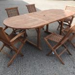 A teak extending garden table, 240 x 100cm overall,