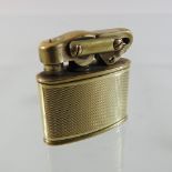 An early 20th century 14 carat gold cased German pocket lighter, with engine turned decoration,