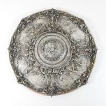 A 19th century electroplated plaque, of circular shape, ornately decorated with relief figures,