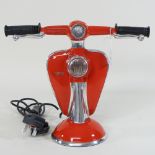 A table lamp, in the shape of a vespa,