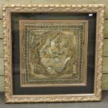An Eastern silk work of a deity, in a display frame,