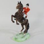 A Beswick model of a huntsman, on a rearing horse,