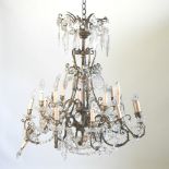An early 20th century brass chandelier, with cut glass drops,