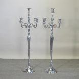 A pair of plated floor standing candelabra,